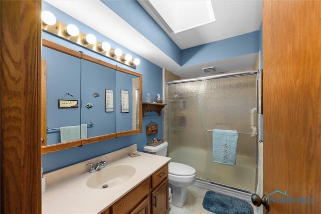2659 Coveview Dr, Toledo, OH 43611 - bathroom featuring a skylight, a stall shower, vanity, and toilet