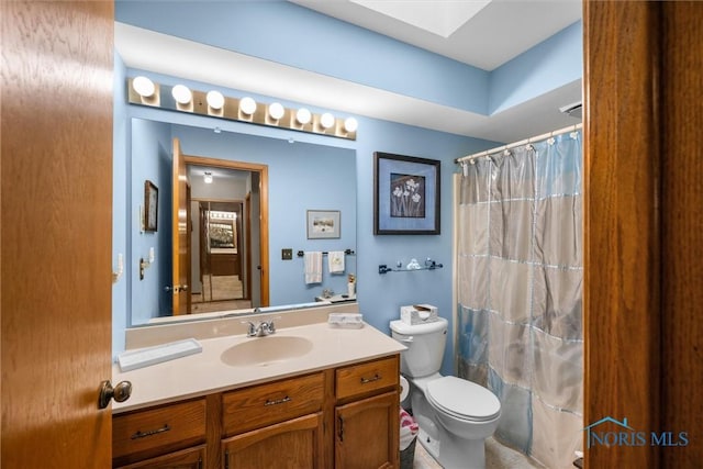 2659 Coveview Dr, Toledo, OH 43611 - bathroom with toilet, vanity, a skylight, and a shower with curtain