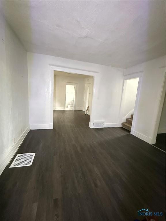 1821 Ridgewood Ave, Toledo, OH 43608 - unfurnished room with stairway, dark wood-type flooring, and baseboards