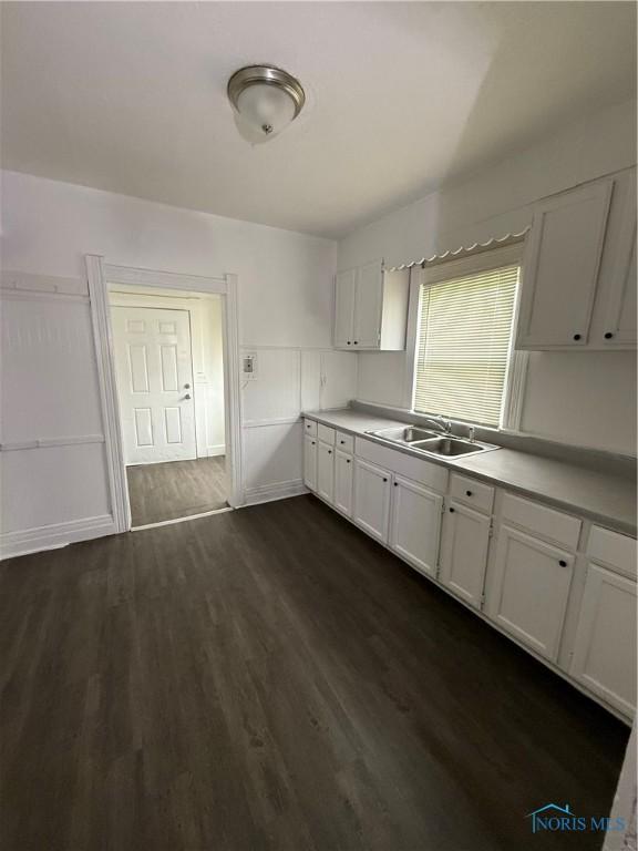 1821 Ridgewood Ave, Toledo, OH 43608 - kitchen featuring a sink, white cabinets, dark wood-style flooring, and light countertops