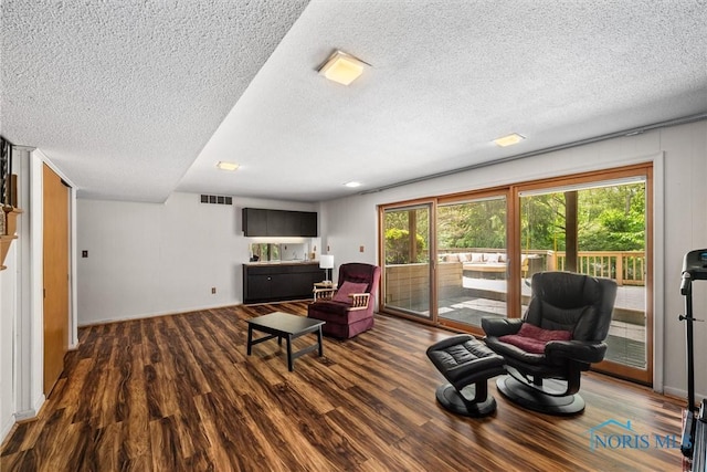 5511 Bent Oak Rd, Sylvania, OH 43560 - living room with dark wood-style flooring, a textured ceiling, and baseboards