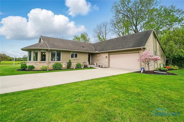 29030 Hufford Rd, Perrysburg, OH 43551 - view of front of property featuring a garage, concrete driveway, a front lawn, and roof with shingles