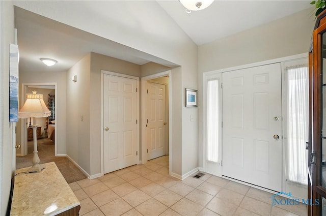 29030 Hufford Rd, Perrysburg, OH 43551 - entrance foyer with light tile patterned floors, healthy amount of natural light, lofted ceiling, and baseboards