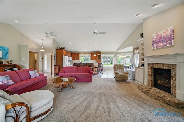 29030 Hufford Rd, Perrysburg, OH 43551 - living room with high vaulted ceiling, ceiling fan, light carpet, a fireplace, and built in shelves