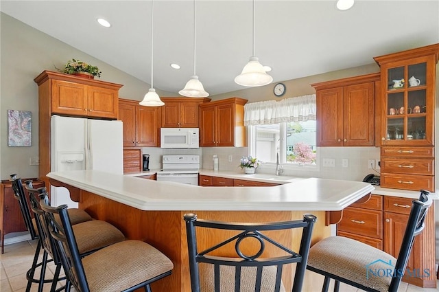 29030 Hufford Rd, Perrysburg, OH 43551 - kitchen with white appliances, tasteful backsplash, light countertops, brown cabinets, and vaulted ceiling