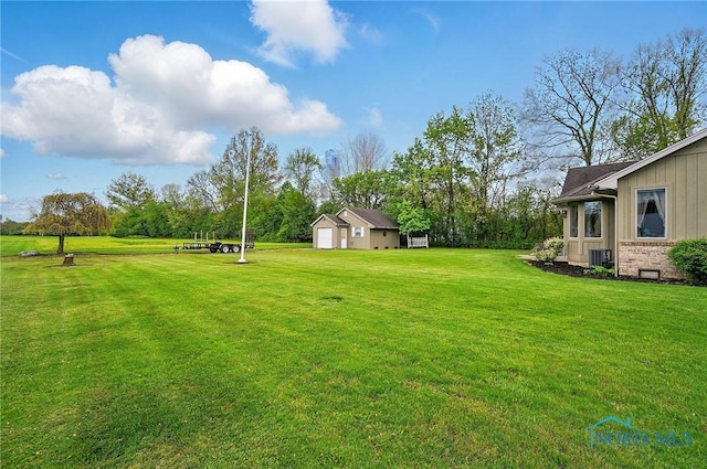29030 Hufford Rd, Perrysburg, OH 43551 - view of grassy yard with a garage, cooling unit, and an outbuilding
