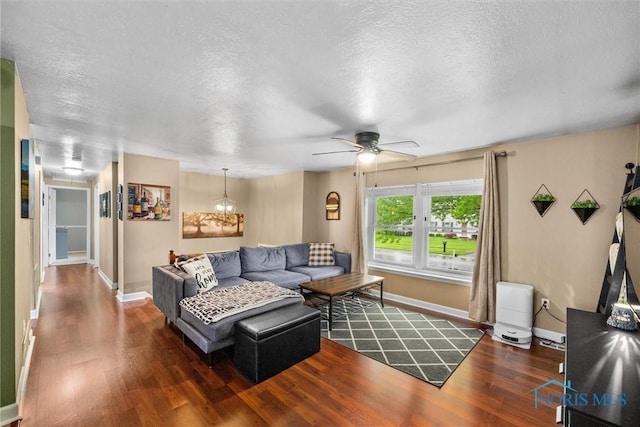 2034 Kellerston Rd, Maumee, OH 43537 - living area with wood finished floors, baseboards, ceiling fan, a textured ceiling, and a chandelier