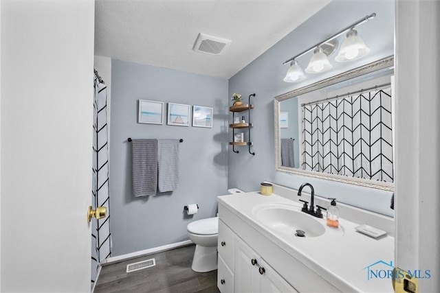 2034 Kellerston Rd, Maumee, OH 43537 - bathroom with wood finished floors, toilet, vanity, baseboards, and a shower with curtain