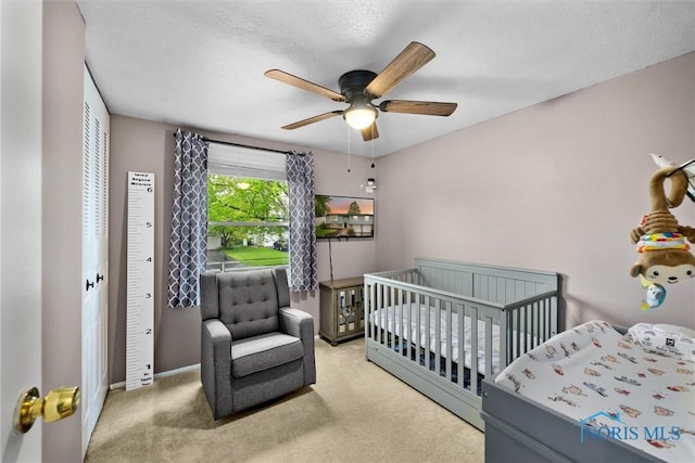 2034 Kellerston Rd, Maumee, OH 43537 - bedroom with carpet floors, a ceiling fan, baseboards, a textured ceiling, and a nursery area