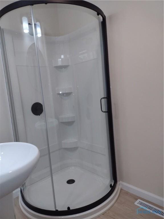S832 County Road 20b, Archbold, OH 43555 - bathroom featuring baseboards, a shower stall, and wood finished floors