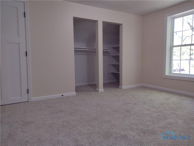 S832 County Road 20b, Archbold, OH 43555 - unfurnished bedroom featuring carpet floors, multiple windows, multiple closets, and baseboards