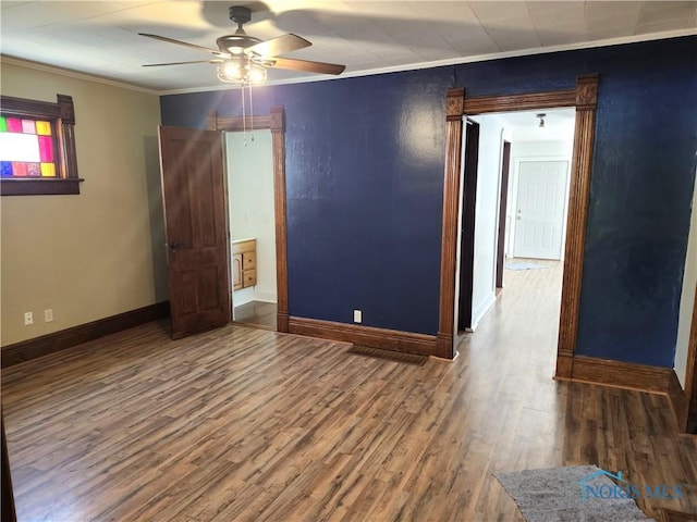 900 Leonard St, Fostoria, OH 44830 - spare room with ceiling fan, baseboards, crown molding, and wood finished floors