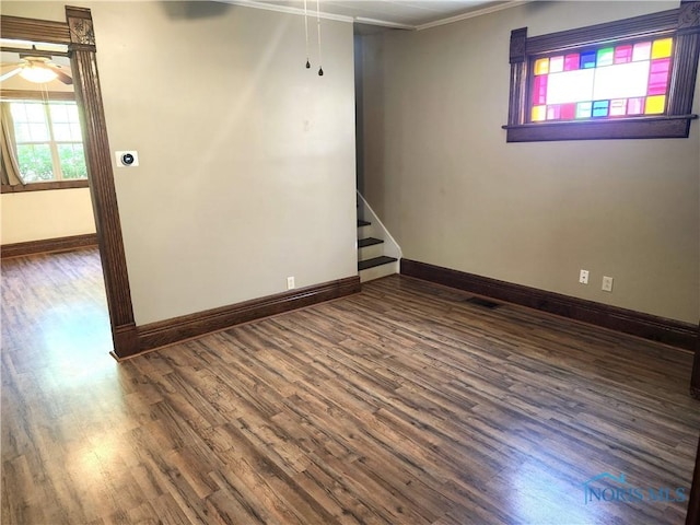 900 Leonard St, Fostoria, OH 44830 - unfurnished room featuring crown molding, baseboards, wood finished floors, stairs, and a ceiling fan