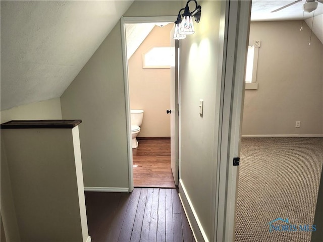 900 Leonard St, Fostoria, OH 44830 - hallway with vaulted ceiling, wood-type flooring, and baseboards