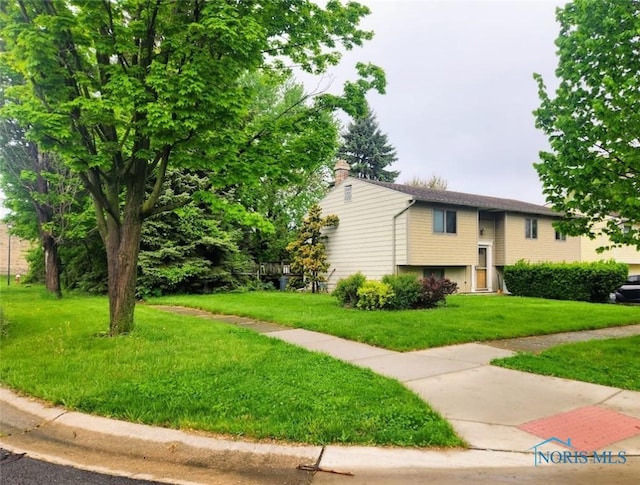 4405 Oldenburg Dr, Toledo, OH 43611 - view of front of home featuring a front yard and a chimney