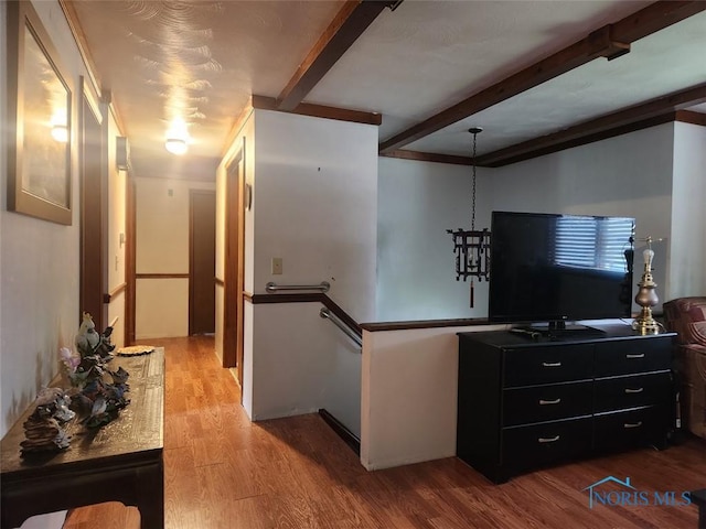 4405 Oldenburg Dr, Toledo, OH 43611 - hallway featuring beam ceiling, wood finished floors, and an upstairs landing