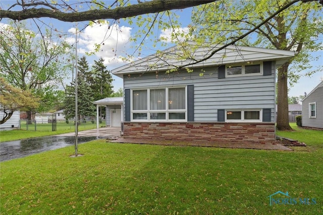1639 Brookside Dr, Findlay, OH 45840 - rear view of property featuring driveway and a carport