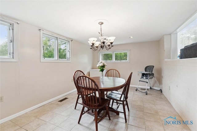 1639 Brookside Dr, Findlay, OH 45840 - dining area with a chandelier, light tile patterned floors, and baseboards