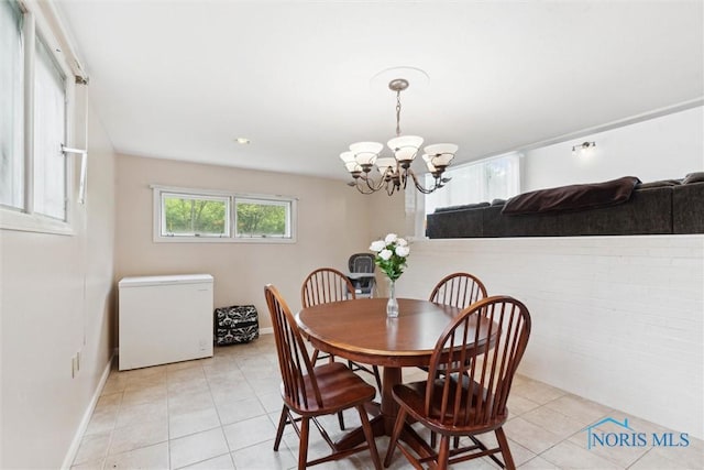 1639 Brookside Dr, Findlay, OH 45840 - dining space with light tile patterned floors, a chandelier, and baseboards