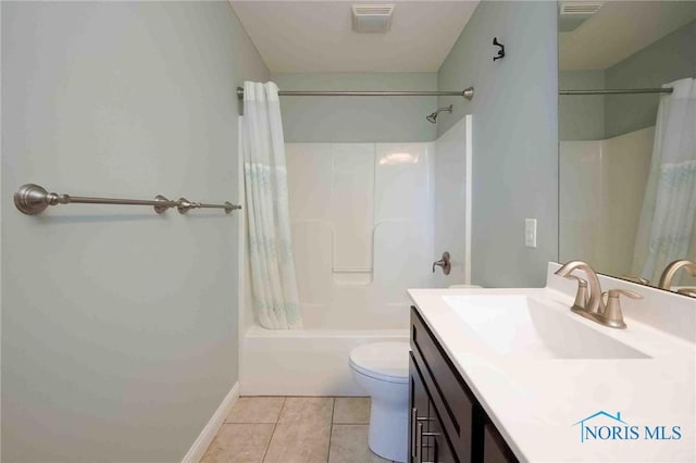 bathroom featuring tile patterned flooring, shower / bath combo, toilet, vanity, and baseboards