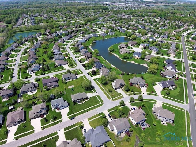 aerial view of property's location featuring a nearby body of water and nearby suburban area