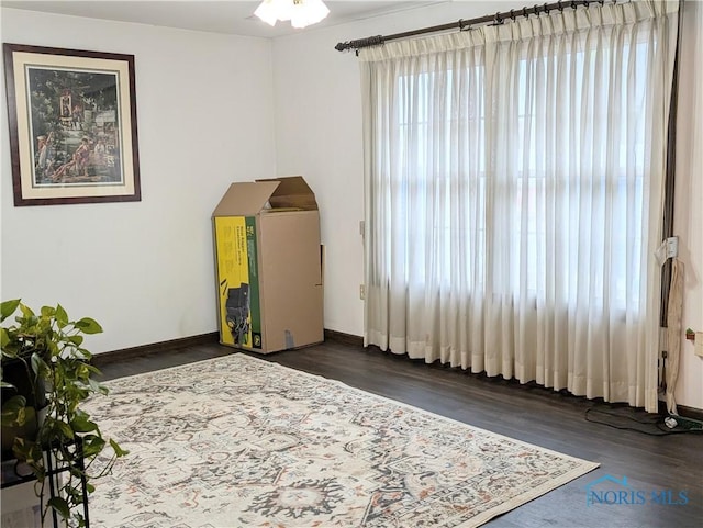 1270 S Park Ln, Wauseon, OH 43567 - spare room featuring wood finished floors, baseboards, and arched walkways