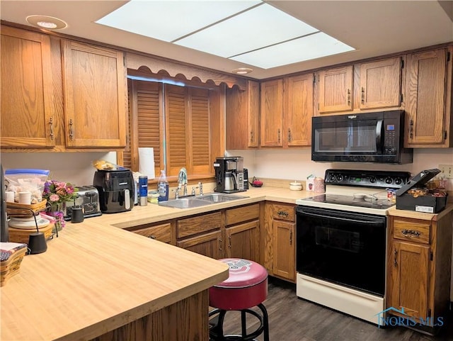 1270 S Park Ln, Wauseon, OH 43567 - kitchen featuring black microwave, electric stove, a sink, and light countertops