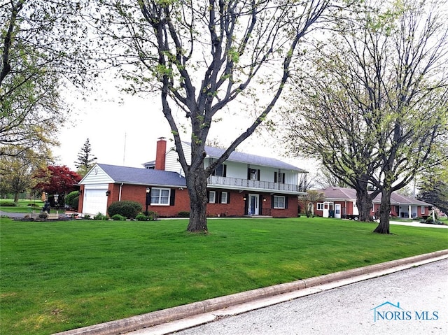 1527 S Ct, Findlay, OH 45840 - traditional-style home featuring brick siding, an attached garage, a chimney, and a front yard