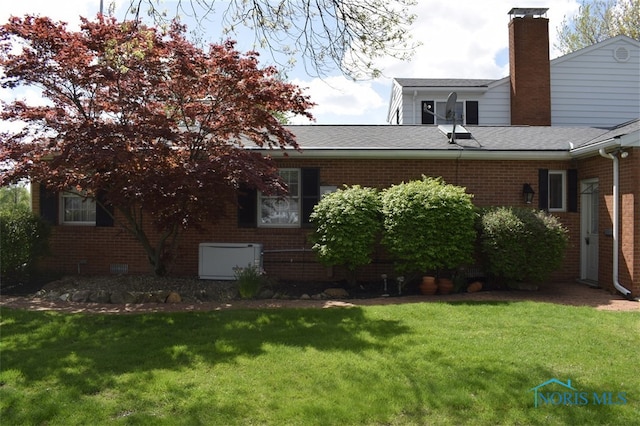 1527 S Ct, Findlay, OH 45840 - back of property with brick siding, a lawn, a chimney, and roof with shingles