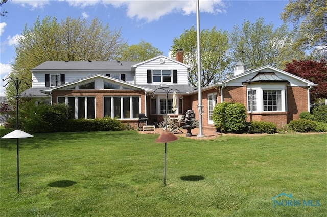 1527 S Ct, Findlay, OH 45840 - rear view of property with brick siding, a chimney, a yard, and a patio