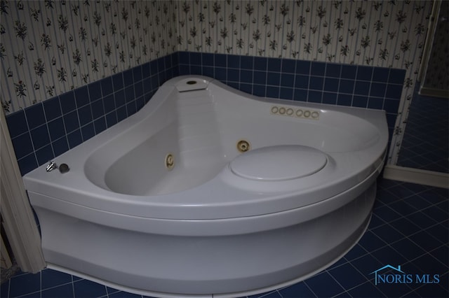1527 S Ct, Findlay, OH 45840 - bathroom with wallpapered walls, a wainscoted wall, tile patterned flooring, a jetted tub, and tile walls