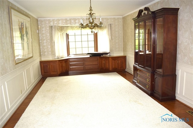 1527 S Ct, Findlay, OH 45840 - unfurnished dining area featuring wallpapered walls, dark wood-style flooring, a chandelier, a wainscoted wall, and crown molding