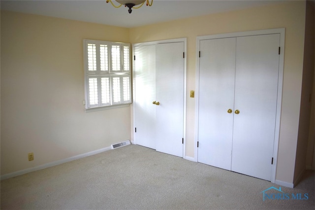 1527 S Ct, Findlay, OH 45840 - unfurnished bedroom featuring multiple closets, carpet, and baseboards
