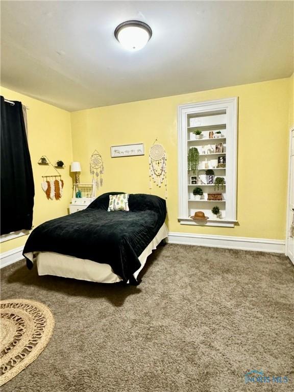 carpeted bedroom with baseboards