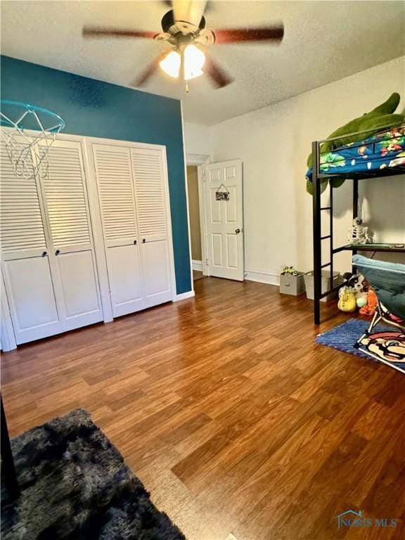 unfurnished bedroom with wood finished floors and ceiling fan