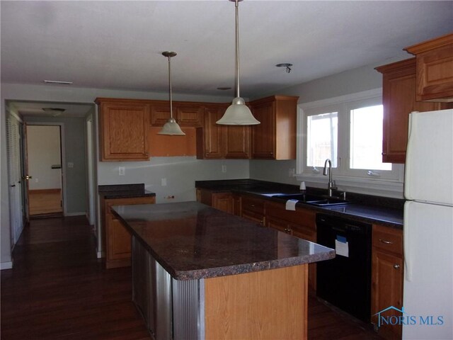 417 Race St, Clyde, OH 43410 - kitchen with freestanding refrigerator, black dishwasher, a sink, dark countertops, and a kitchen island