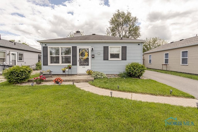 210 Willamont Rd, Toledo, OH 43612 - view of front of home with a front lawn and a chimney