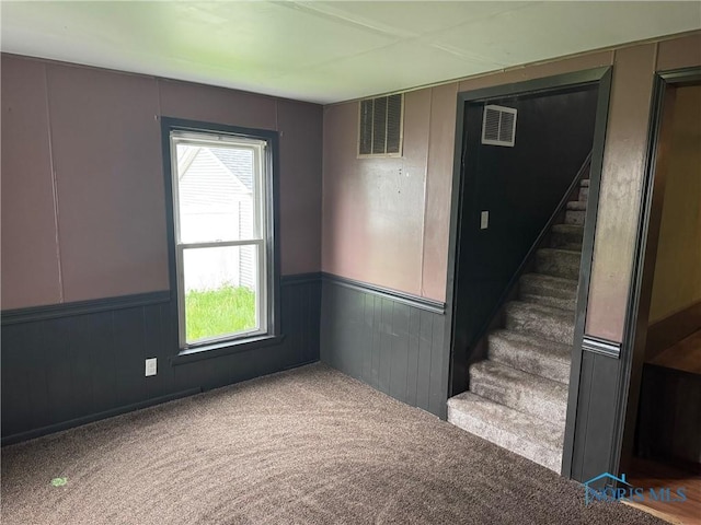 215 E Bryan St, Bryan, OH 43506 - stairway featuring carpet floors and wainscoting