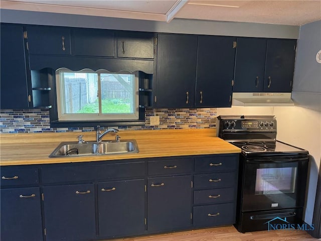 215 E Bryan St, Bryan, OH 43506 - kitchen with electric range, under cabinet range hood, a sink, light countertops, and decorative backsplash