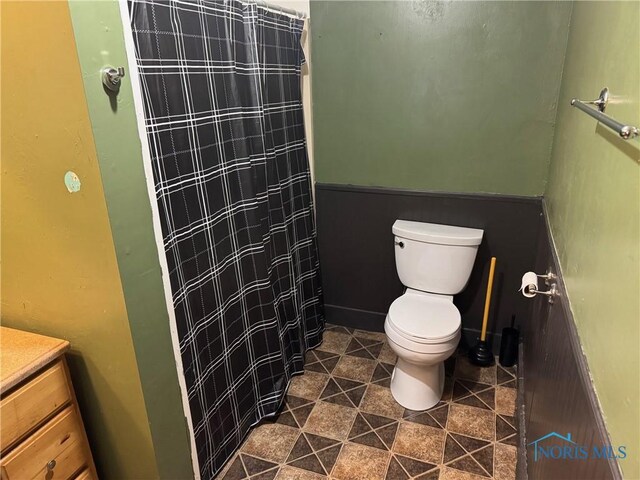 215 E Bryan St, Bryan, OH 43506 - bathroom with toilet, a shower with curtain, vanity, and tile patterned floors