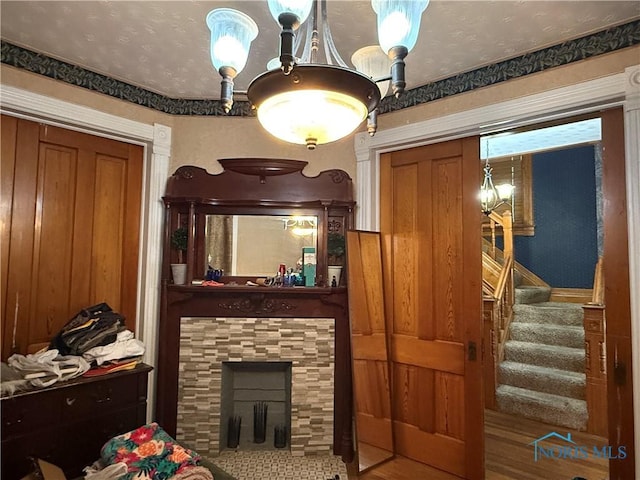 1023 Buckland Ave, Fremont, OH 43420 - living room with stairway, a tile fireplace, and a chandelier