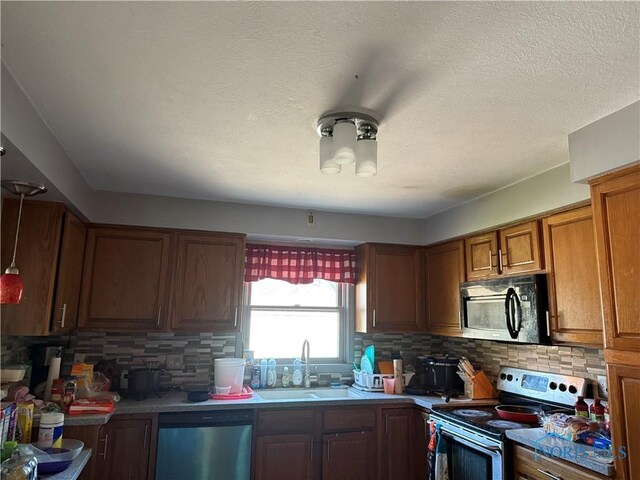 1023 Buckland Ave, Fremont, OH 43420 - kitchen with stainless steel electric range oven, dishwasher, a sink, tasteful backsplash, and brown cabinetry