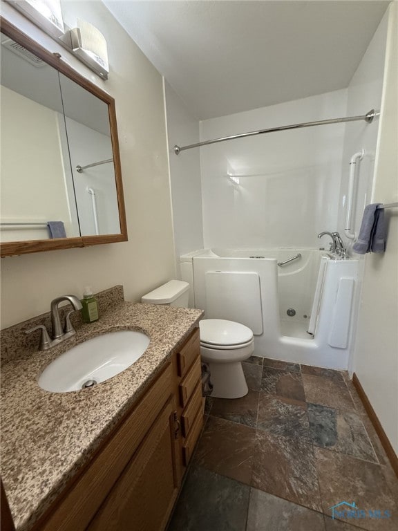 512 Fugate Dr, Defiance, OH 43512 - bathroom with stone tile floors, toilet, vanity, tub / shower combination, and baseboards