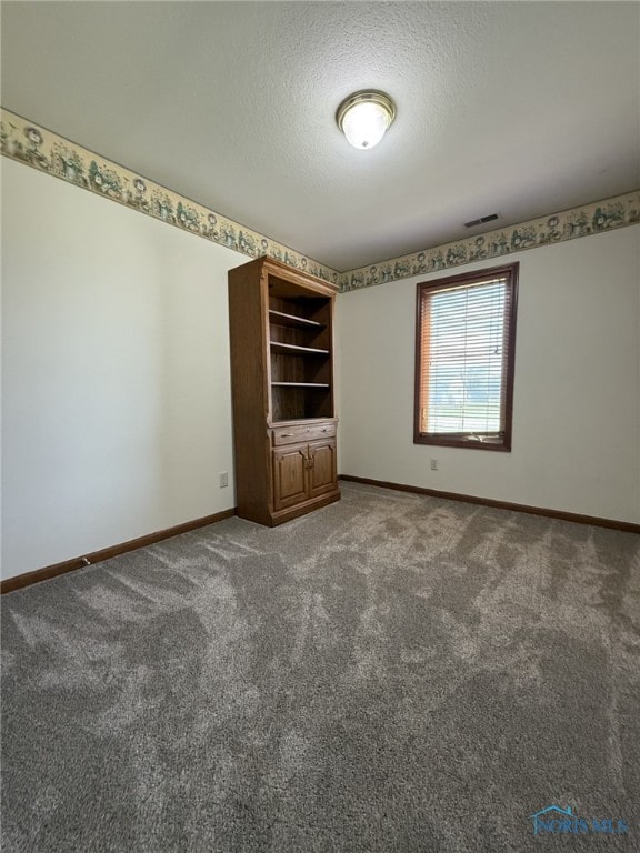 512 Fugate Dr, Defiance, OH 43512 - carpeted spare room with baseboards and a textured ceiling