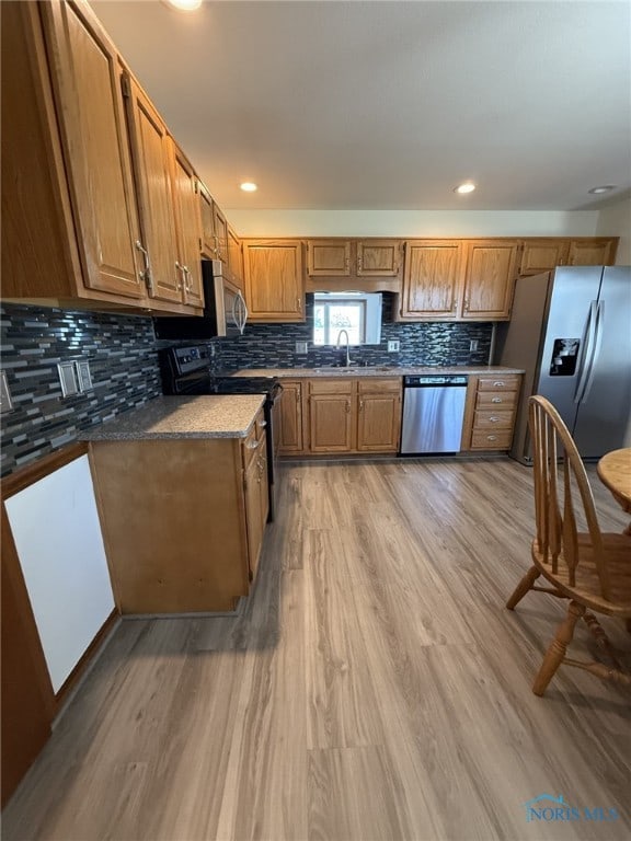 512 Fugate Dr, Defiance, OH 43512 - kitchen featuring stainless steel appliances, a sink, brown cabinetry, light wood-style floors, and recessed lighting