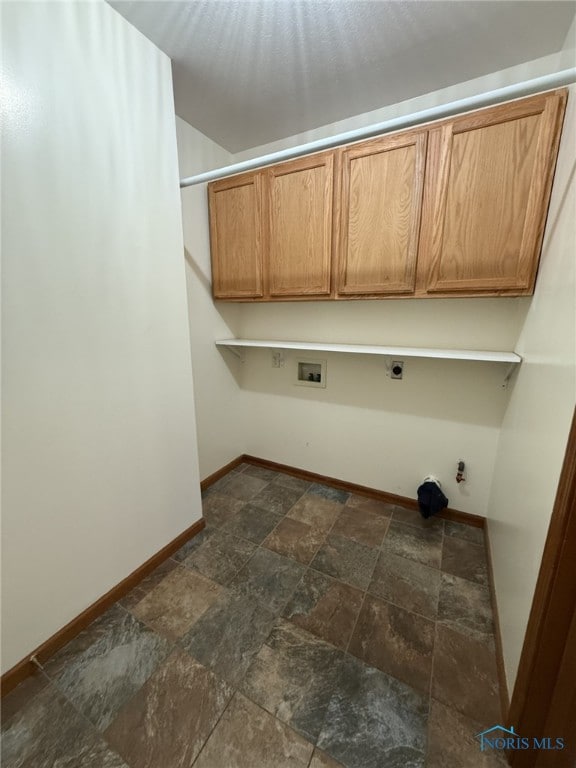 512 Fugate Dr, Defiance, OH 43512 - clothes washing area with stone tile floors, gas dryer hookup, baseboards, washer hookup, and cabinet space