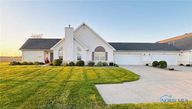 1021 Mohawk Way, Wauseon, OH 43567 - single story home with a chimney, a lawn, and concrete driveway