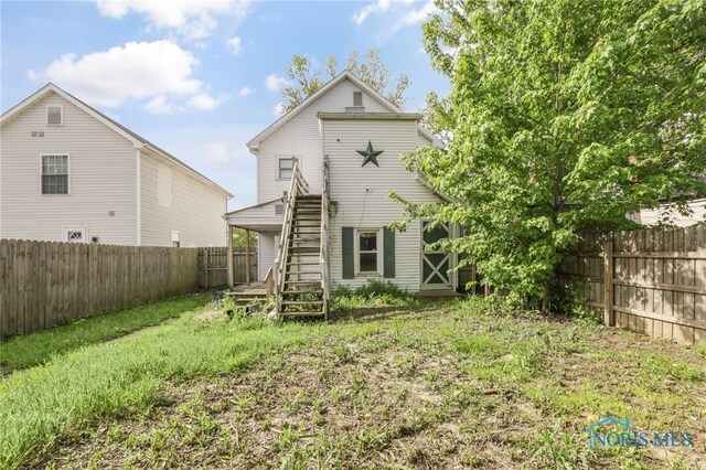 308 Crittenden Ave, Toledo, OH 43609 - rear view of house featuring stairway and a fenced backyard