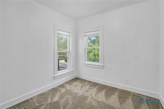 308 Crittenden Ave, Toledo, OH 43609 - spare room with dark colored carpet and baseboards