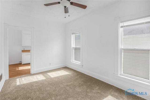 308 Crittenden Ave, Toledo, OH 43609 - empty room with light colored carpet, a ceiling fan, healthy amount of natural light, and baseboards